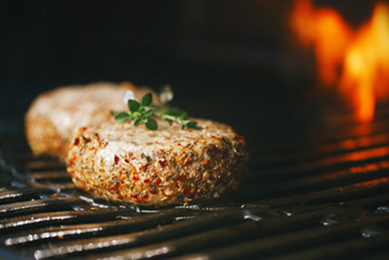 Lamb chop from Superior Farms on grill with rosemary sprig